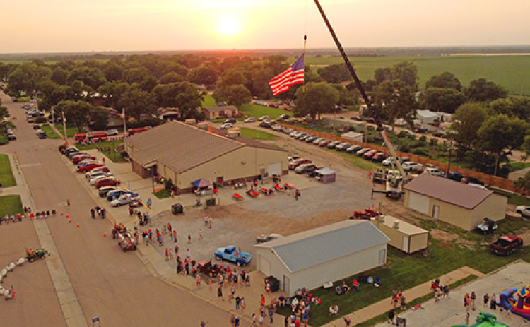 Old Glory flies high above the Phillips Memorial Hall Friday evening as the community came together to celebrate America’s 250th birthday.