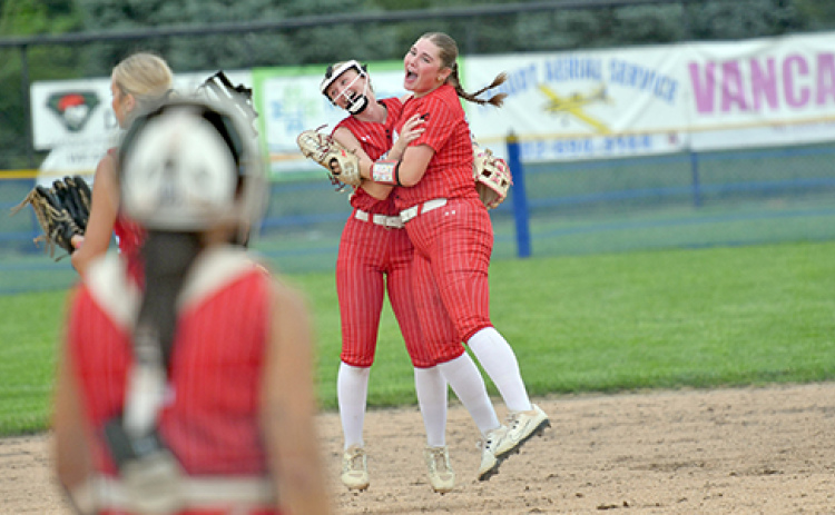 Novella Stevens (far right) and Vivi Fahrnbruch celebrate a defensive double play during Aurora’s 5-2 win over Auburn Friday. Stevens would later blast her first home run of the season against Malcolm.