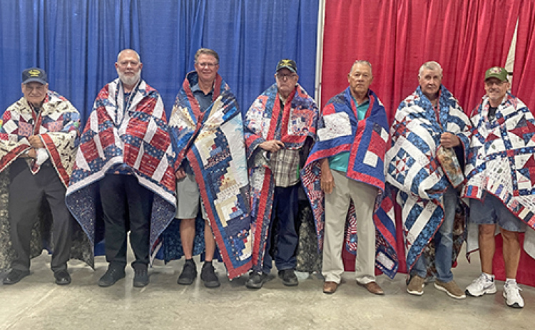 Seven Hamilton County veterans were honored with Quilts of Valor at the Hamilton County Fair on Sunday. Pictured from left are James Garfield, Barry Horner, Jim R. Nachtigal, Harold Skidmore, Arlie Johnson, Dale Quick and Cody Quick.