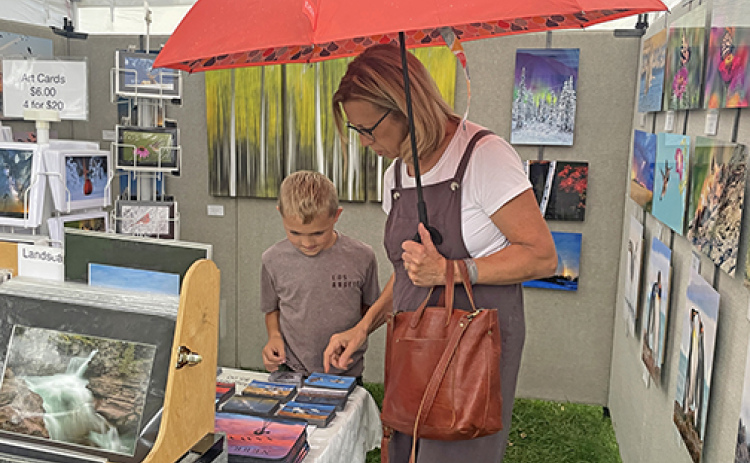 Shoppers browse a booth at last year's Art Walk Aurora.