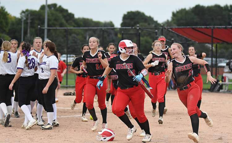 Vivi Fahrnbruch, right, and her teammates prepare to celebrate after a run-rule victory over Fillmore Central. In Aurora’s four games last week, the Huskies plated 49 runs, all victories.