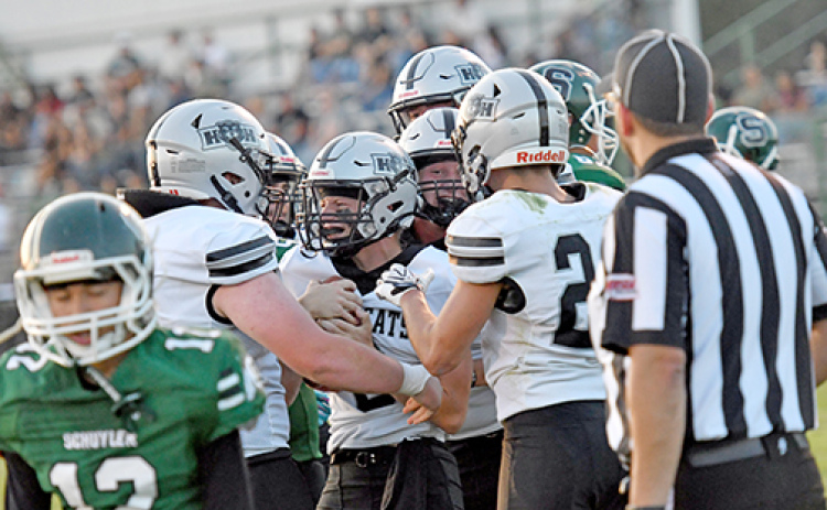H&H quarterback River Glinsmann is mobbed by his offensive linemen after scoring a rushing touchdown in a 43-0 win over Schuyler Friday night.