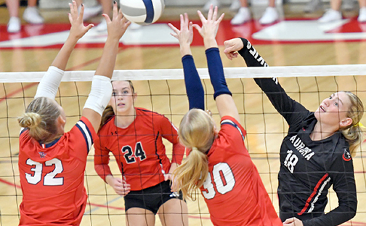 Paisley Bartek pushes an attack past two Adams Central defenders during Aurora’s three-set loss to the Patriots at home Sept. 15.