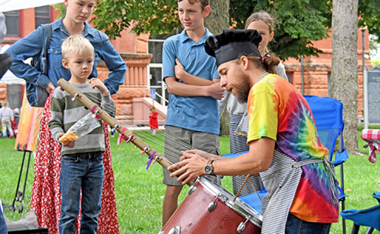 Art Walk Aurora featured over 30 artists at the Hamilton County Courthouse lawn on Sunday with patrons of all ages getting a chance to see and buy the various art pieces on display. Casey Hollingsworth, the inventor of The Music Kitchen, showcases an instrument he made inspired by the Kora, a stringed instrument traditionally made in West Africa.