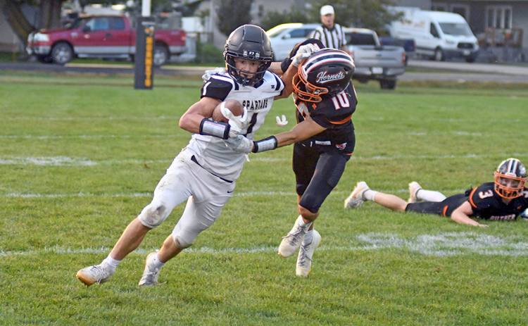 Ben Gordon wrestles down Ansley-Litchfield’s Owen Brott during Giltner’s 44-38 wild Homecoming win Friday. Gordon had seven tackles in the game that featured a three-hour weather delay.
