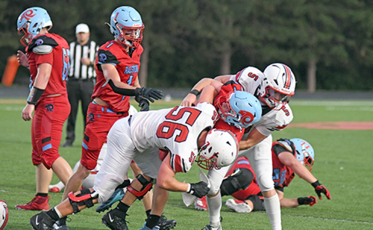 Aurora senior Ryan Carlson made his season debut Friday, getting in on an assisted tackle here with teammate Wyatt Pollet.