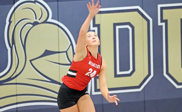Baya Chamness puts up a serve during Aurora’s dramatic five-set victory at York Thursday.