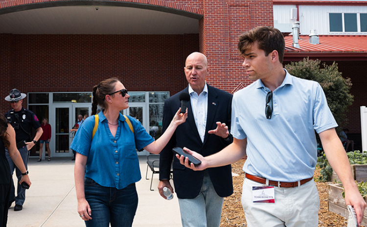 Jesse Harding Campbell, pictured at left, conducts an interview with Sen. Pete Ricketts while walking through the Nebraska State Fair. Campbell, founder of Marsh Wren Creative, recently moved with her family to the rural Phillips area.