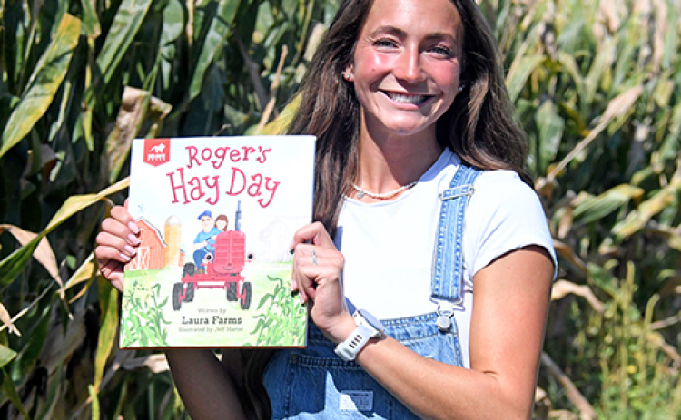 YouTube creator Laura “Laura Farms” Wilson displays her children’s book, “Roger’s Hay Day” that will be released next month. The book was created in collaboration with FFA to introduce young children to different fields in agriculture.