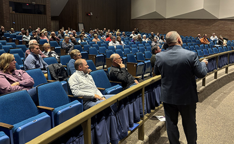 Aurora Supt. Jody Phillips, right, looks toward the screen as he explains details of a proposed $84 million school bond issue to a community group attending Monday’s information session. A similar session is scheduled for Nov. 4, beginning at 6:15 p.m. at the Middle School Theater.