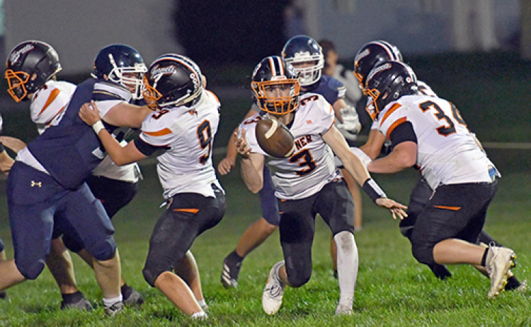 Giltner QB Brody Rudy pitches the ball on an outside run play near the goal line during the Hornets’ 62-50 loss at Grand Island Lutheran Thursday.