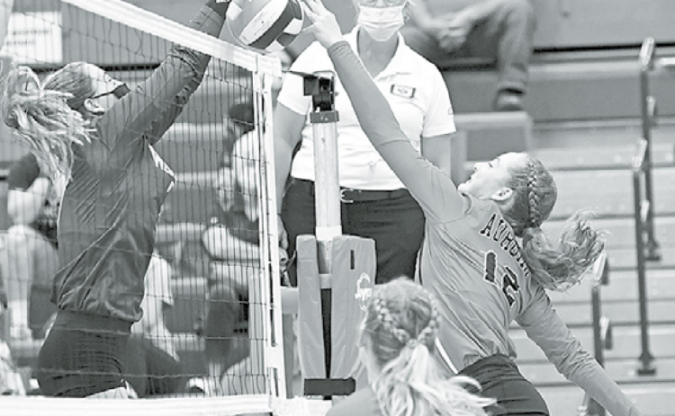 Rachel Hunter fights for control at the net during second set action against Wahoo Thursday. The Lady Huskies lost in three to the Class C-1 preseason No. 1 team. News-Register/Richard Rhoden
