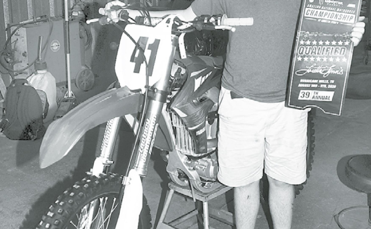 Karson Meyer, an Aurora sophomore, holds the ticket he earned to this week’s Amateur National Motocross Championship at Loretta Lynn’s Ranch in Tennessee. News-Register/Kurt Johnson