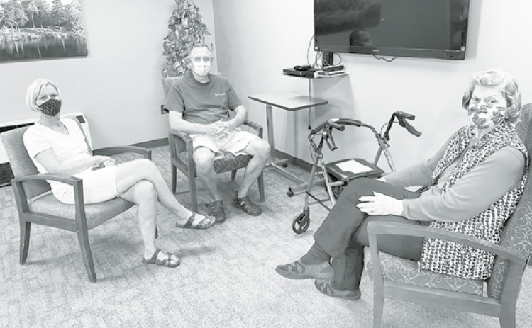 Memorial Community Care resident Rosie Reisinger, right, enjoys her first visit in four months with family members. Pictured at left are Rosie’s daughter and son-in-law, Martha Sue and Dayne Brehm. Courtesy photo