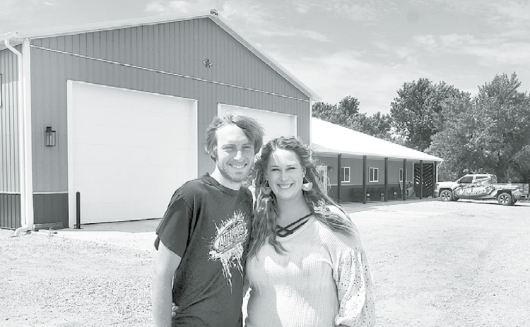 Troy and Kelsey Hofmann stand in front of their new building just north of Aurora’s I-80 intersection, which is now home to After Hours Grafix and Urban Creations hair salon, which has a private entrance on the east side. News-Register/Kurt Johnson