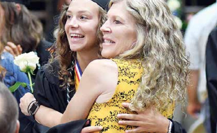 Giltner senior Sydney Janzen (left) and her mother, Debbie, grin the cameras during Giltner’s information on th graduation ceremony Sunday. News-Register/Richard Rhoden
