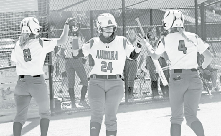 Kaleigh Metzger (middle) high fives teammates Kylie Larson (8) and Zarian Arends after both of them scored during a 13-2 win over St. Paul Friday. News-Register/Richard Rhoden