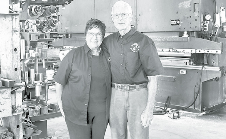 Jim and Kay Lindquist stand in the midst of equipment at their Giltner blacksmith shop. Jim founded the company in 1969 and Kay joined him as business manager in 1991. News-Register/Kurt Johnson