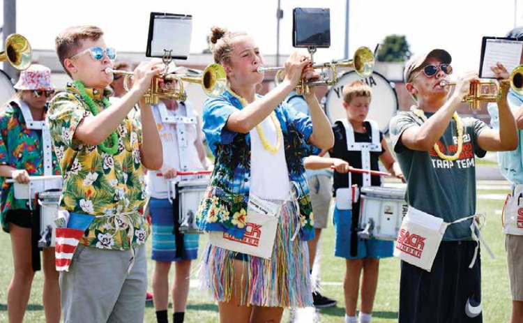 Fully embracing Thursday’s “beach day” theme for Aurora’s 2020 band camp were, from left, trumpeters Cole Krejci (9), Emi Huls (9) and Wyatt James (10). News-Register/Cheyenne Rowe